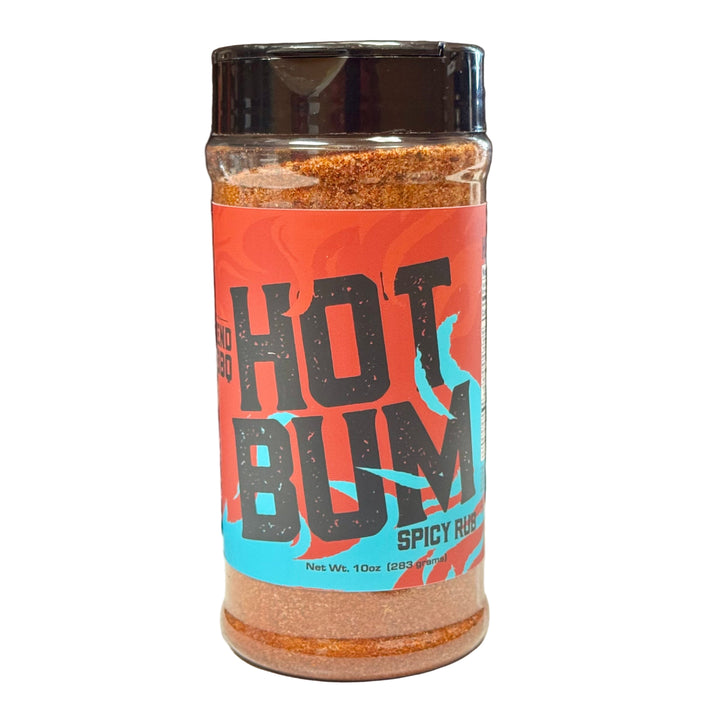 Spicy rub container labeled 'Hot Bum' on a desk with a laptop in the background